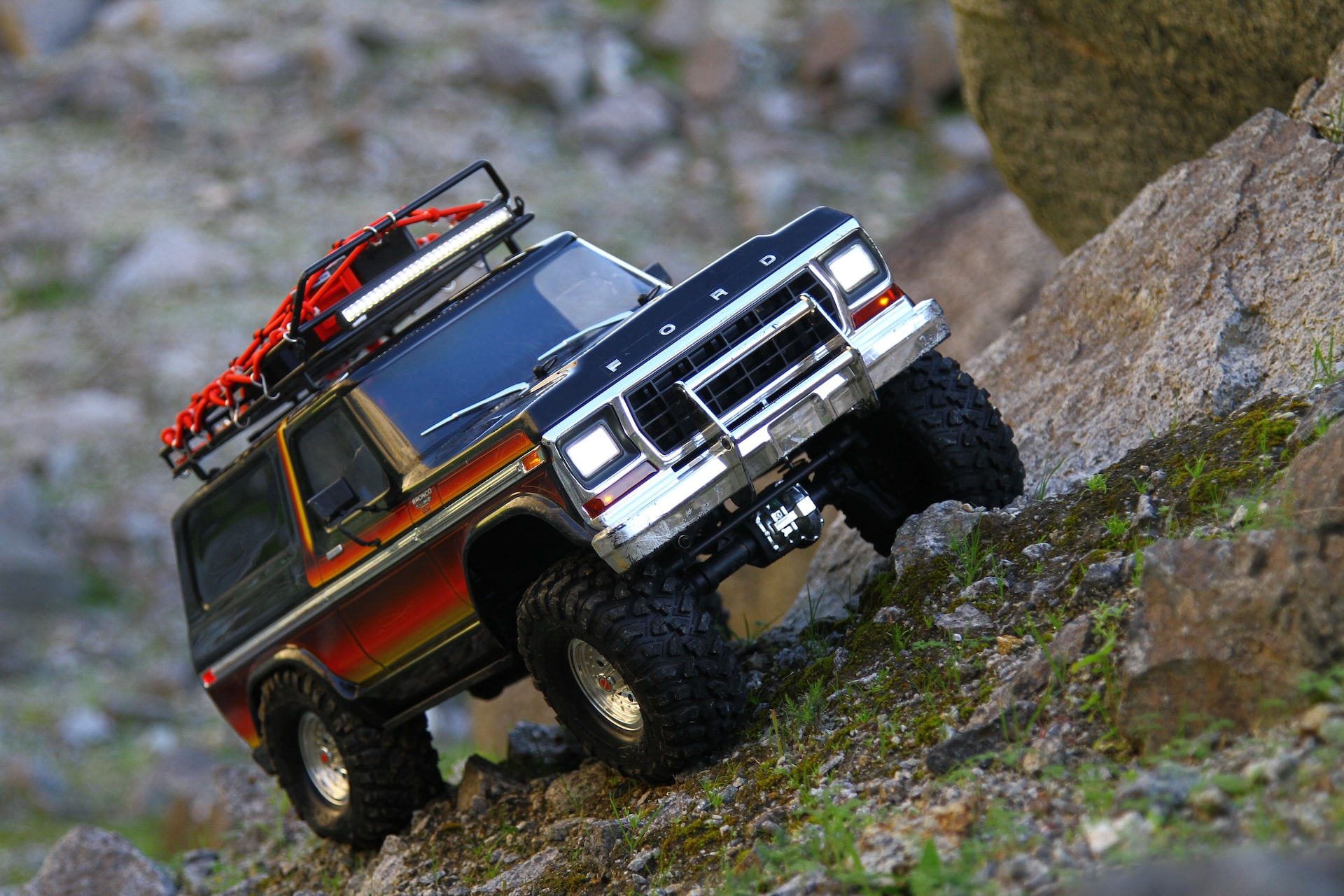 red and black jeep wrangler on dirt road during daytime